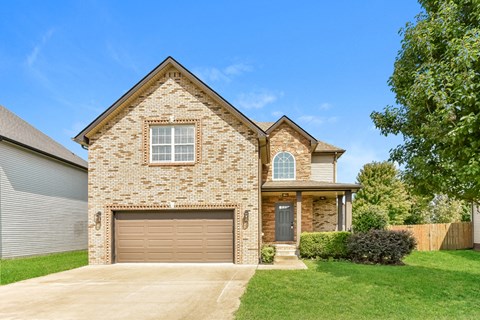 A house with a garage door and a window.