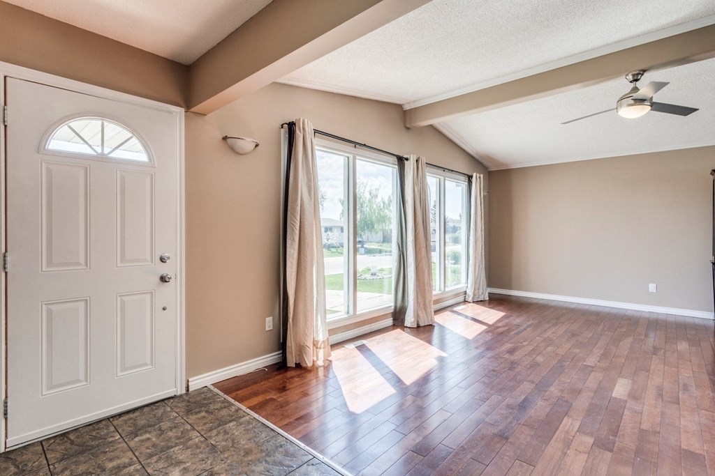 an empty living room with a door to a patio