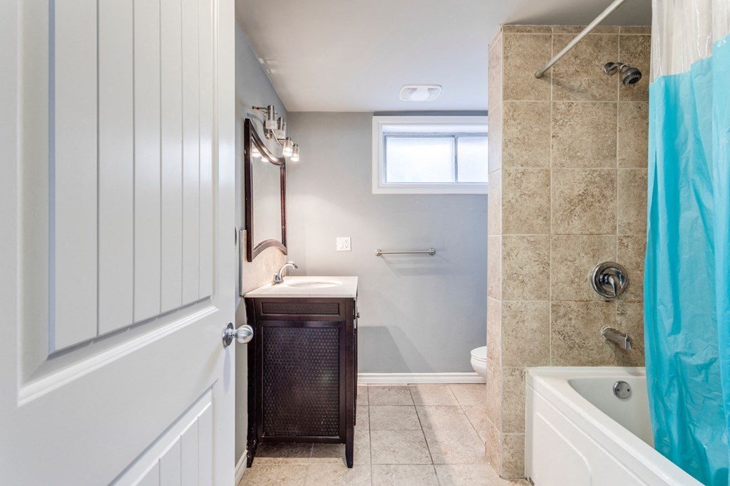 a bathroom with a sink and a shower and a tub