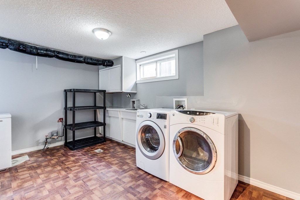 an empty laundry room with a washer and a dryer in it