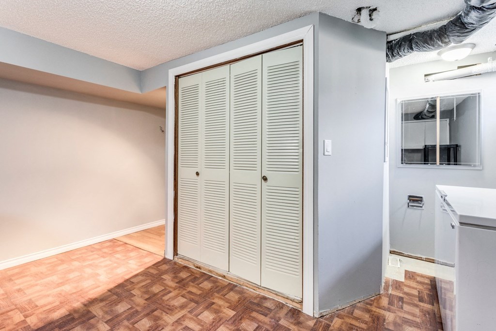 an empty room with a closet and a bathroom