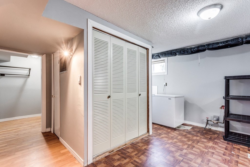 an empty living room with a closet and a bathroom