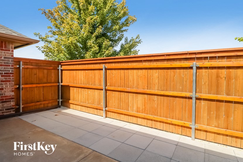 A wooden fence with a metal post in the middle.
