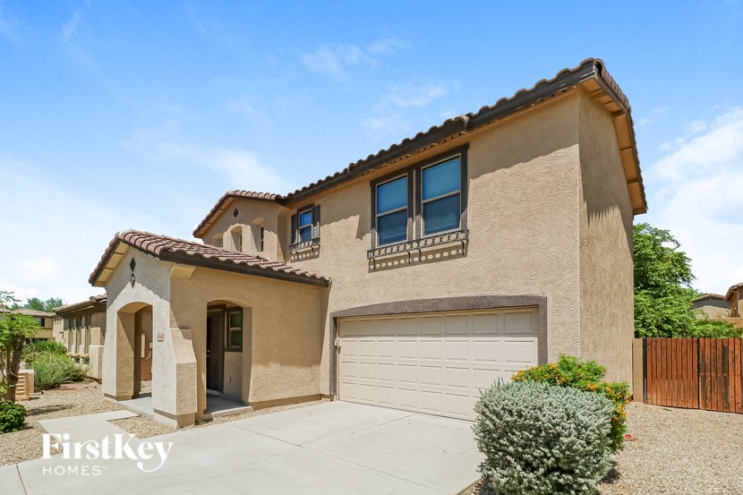 a beige house with a garage door