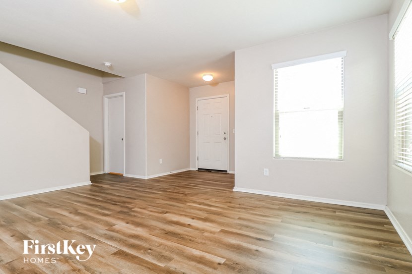 the living room and dining room with wood flooring