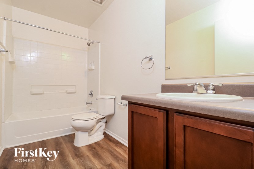 a bathroom with a toilet and a sink and a mirror