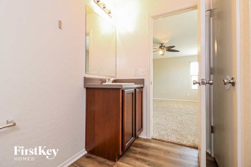 a bathroom with a sink and a mirror and a closet
