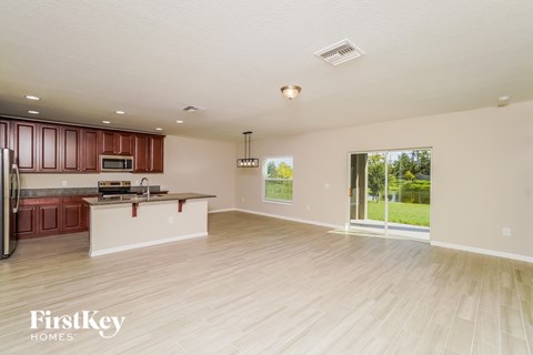 A spacious kitchen with wooden cabinets and a white countertop.
