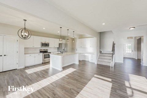 a large kitchen with white cabinets and a large island