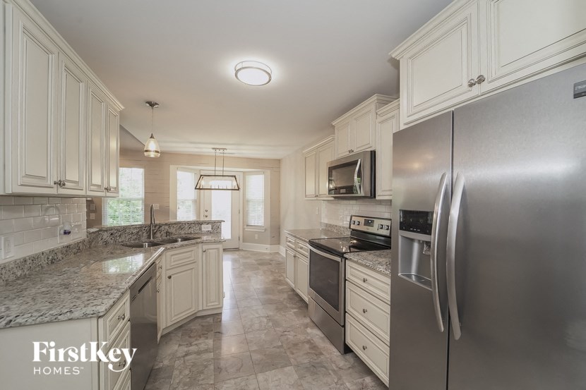a kitchen with stainless steel appliances and white cabinets