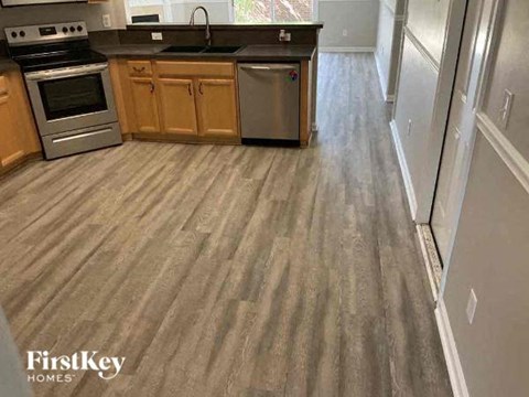 a kitchen with a wooden floor and a stove