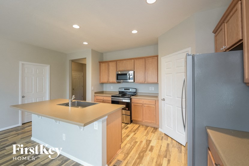 A kitchen with wooden cabinets and a sink.