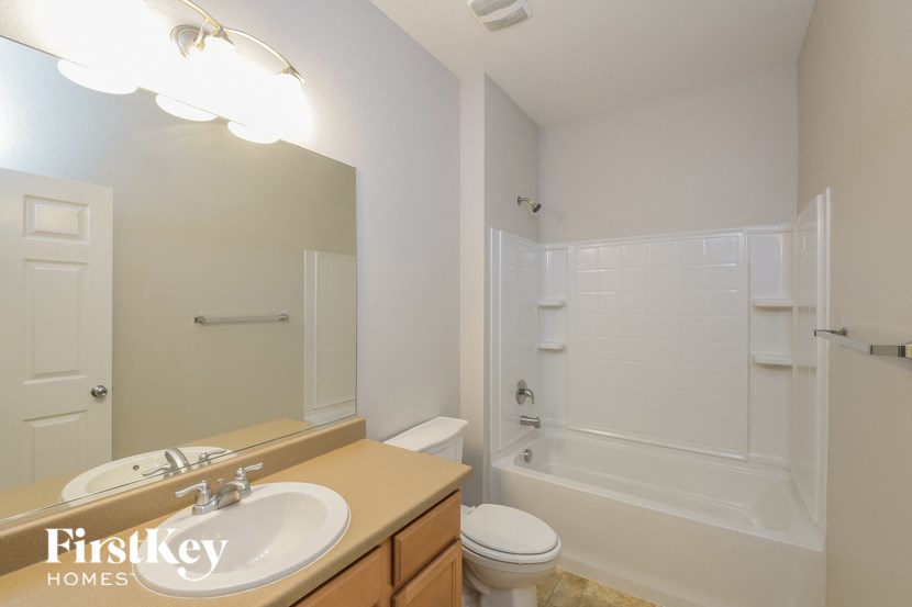 A bathroom with a sink, toilet, and bathtub.