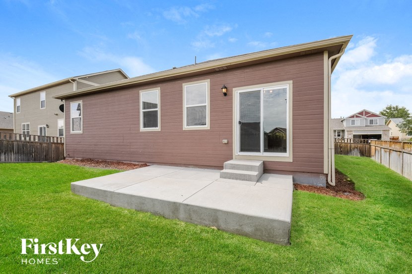 A house with a brown exterior and a grey roof is for sale.