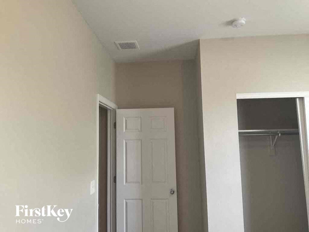 A white door is in a room with a white ceiling.