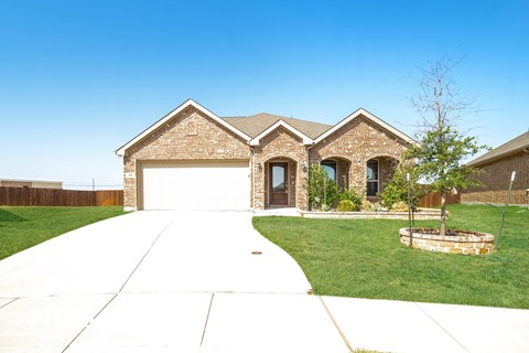 a house with a white garage door and a lawn