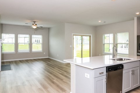 A kitchen with white cabinets and a dishwasher.