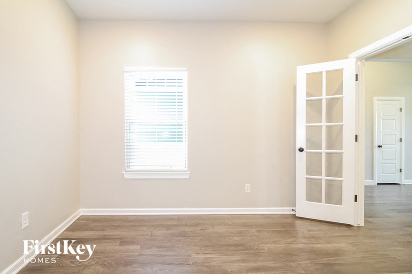 a empty room with a door and a window