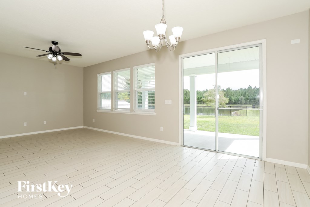 an empty living room with a sliding glass door to the patio