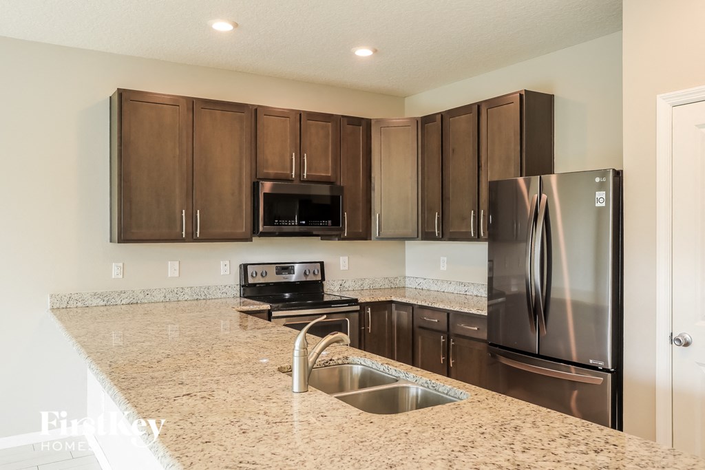 a kitchen with stainless steel appliances and granite counter tops