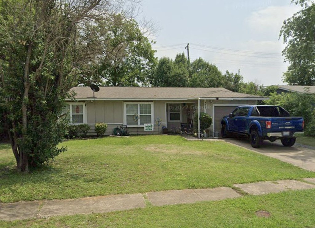 a house with a blue truck parked in front of it