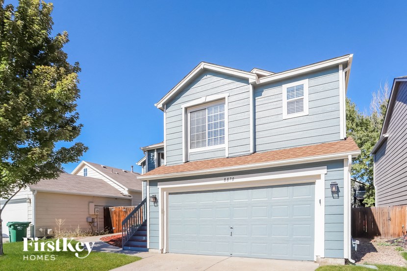 a blue and white house with a white garage door