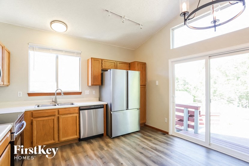 an empty kitchen with a refrigerator and a sink