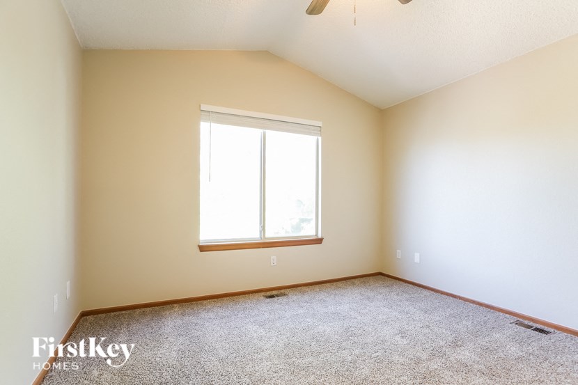 a empty room with a window and carpet