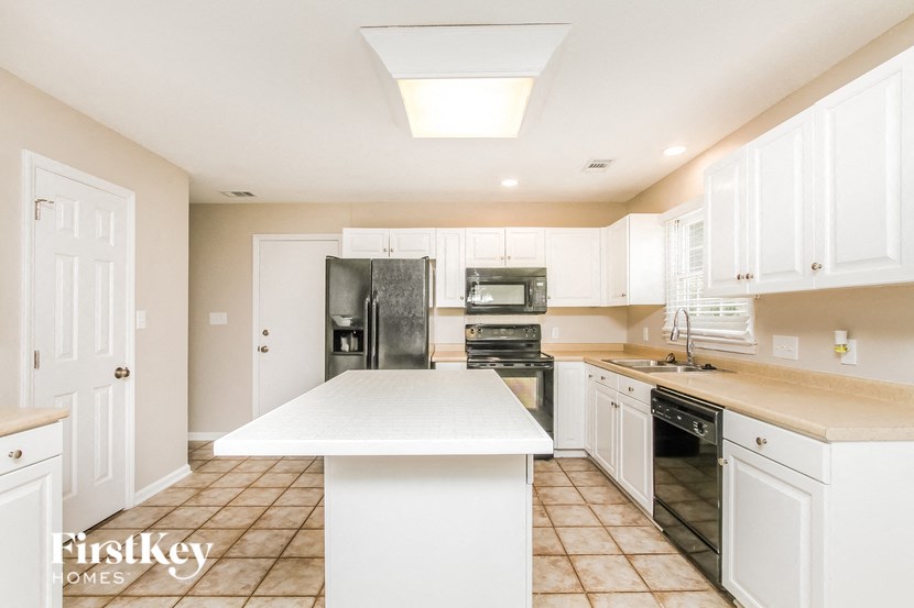 a kitchen with white cabinets and a white counter top