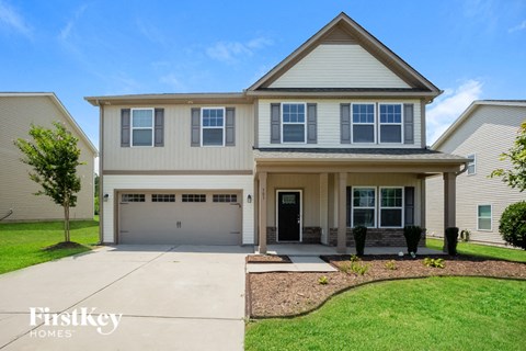 a white house with a driveway and a garage door
