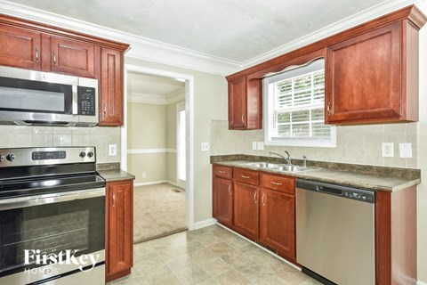 a kitchen with a stove and a sink and a microwave
