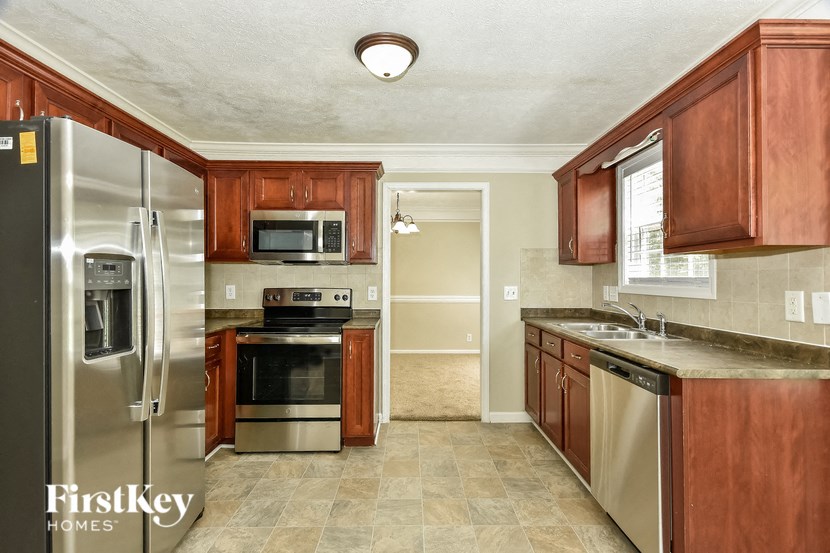 a kitchen with stainless steel appliances and wooden cabinets