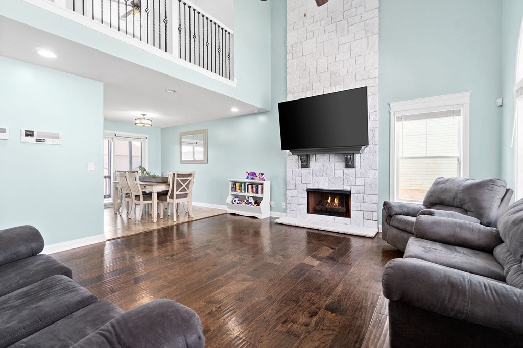 a living room with a fireplace and a tv