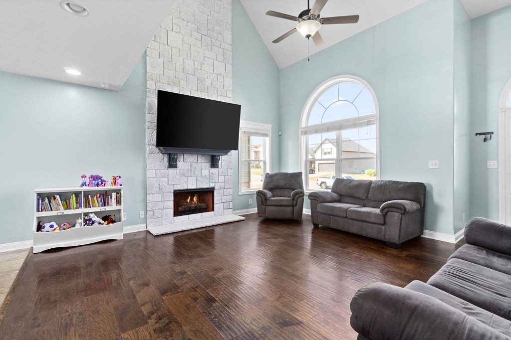 a living room with two couches and a fireplace and a tv