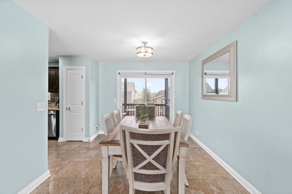 a dining room with blue walls and a table and chairs