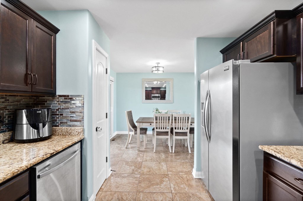 a kitchen with stainless steel appliances and a dining table
