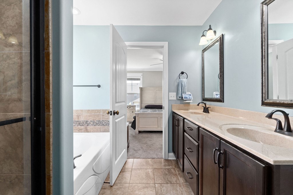 a bathroom with a sink and a shower and a tub