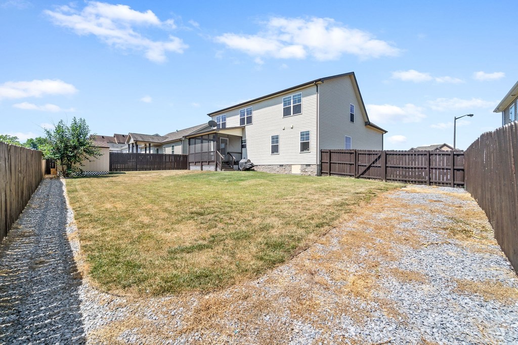 the backyard of a house with a yard and a fence
