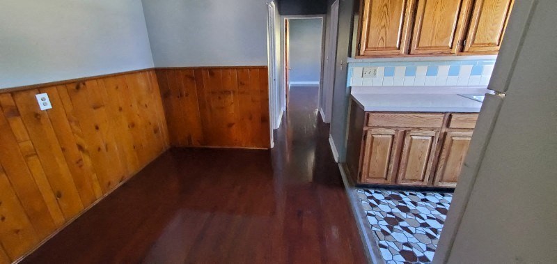 a kitchen with wooden floors and wooden cabinets