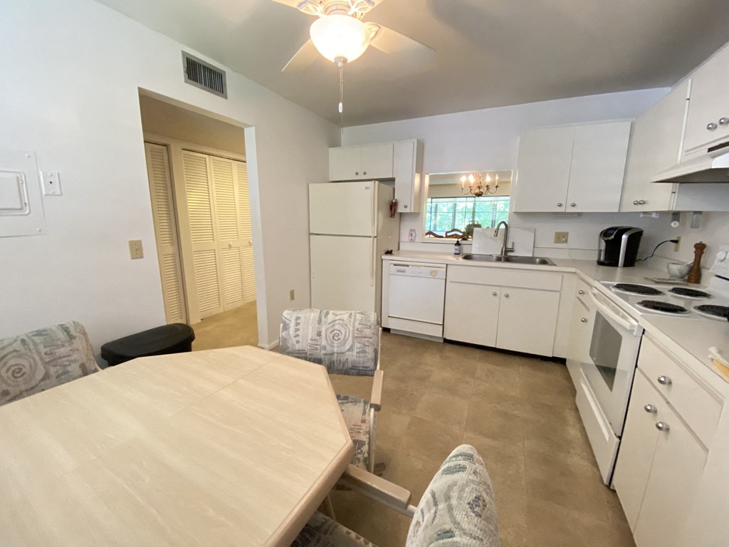 an open kitchen and dining room with a table and chairs