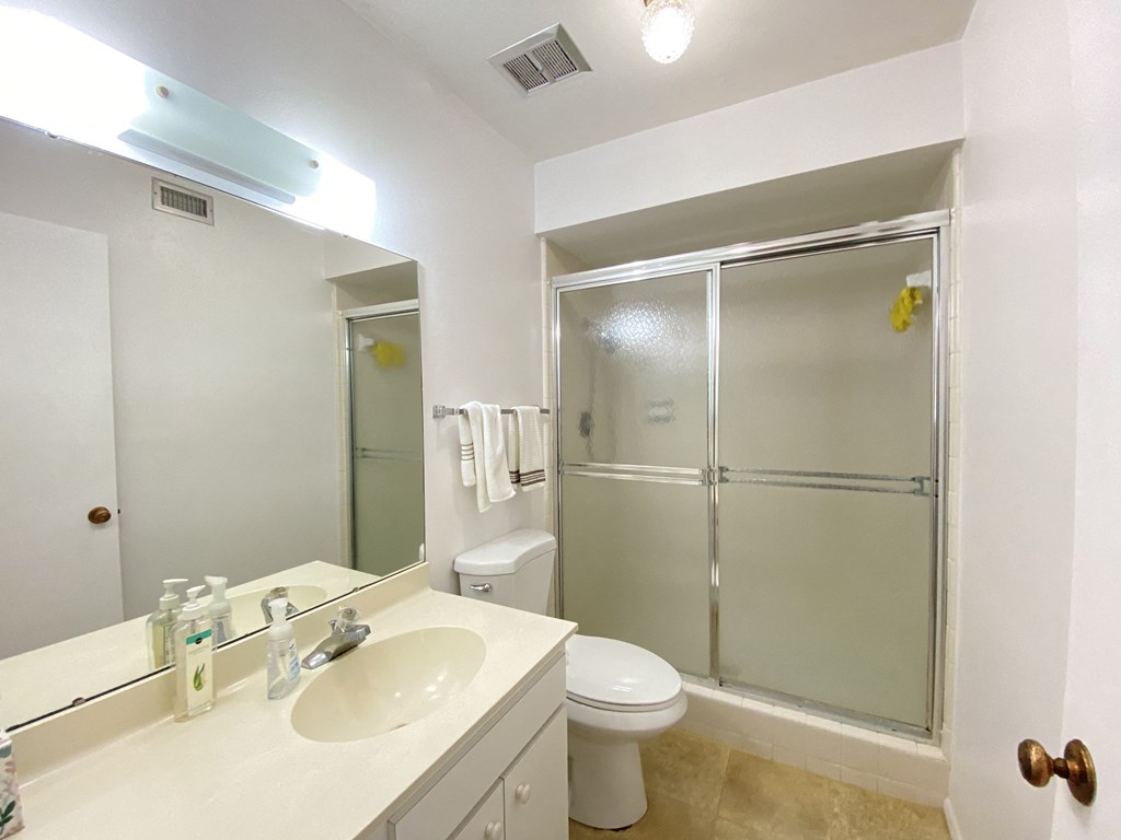 a bathroom with a sink toilet and shower