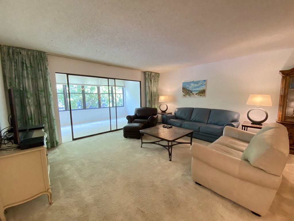 the living room has a large sliding glass door to the patio