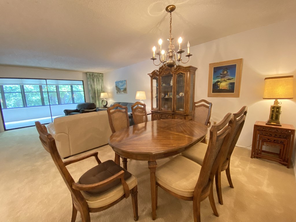 a dining room with a table and chairs and a couch