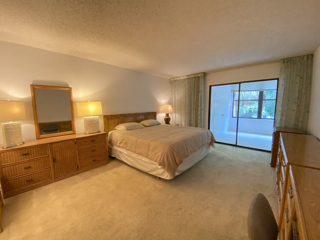 a bedroom with a bed and a dresser and a window