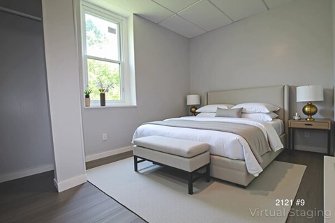 A bedroom with a large bed and a window.