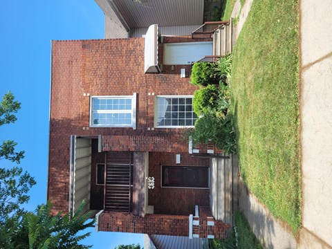 a view of the back of a brick house from above