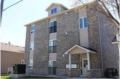 A large brick building with a small porch and a covered entrance.