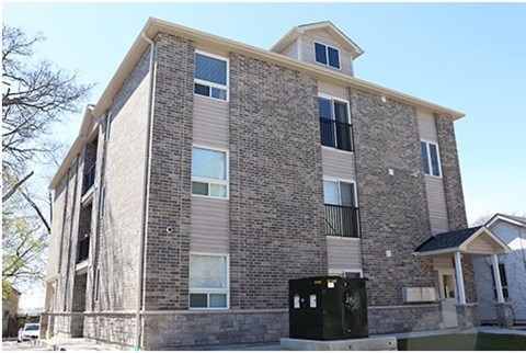 A modern building with a mix of stone and siding exterior.