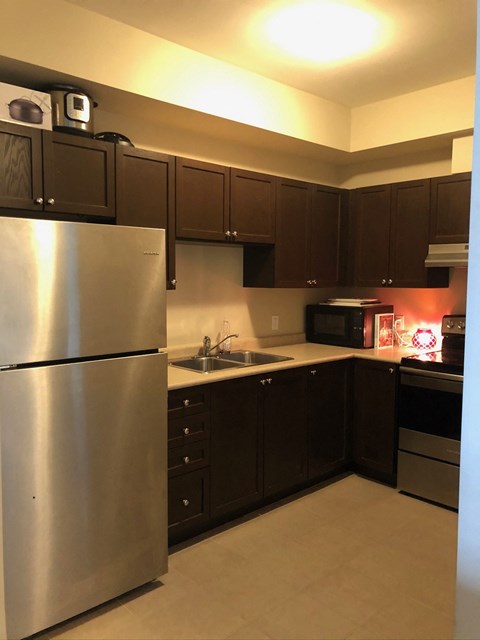 a kitchen with stainless steel appliances and black cabinets