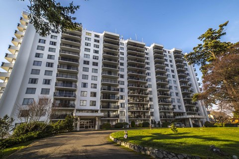 a large apartment building with a driveway in front of it